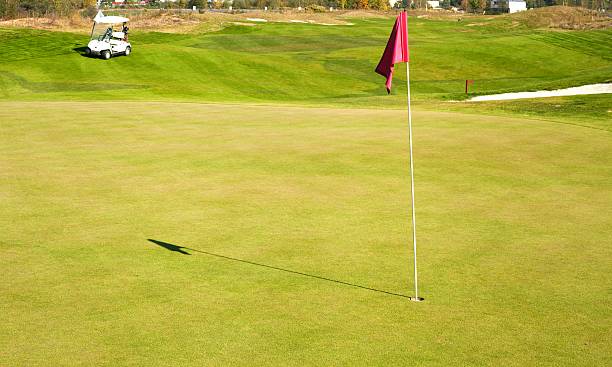 istock Golf course landscape with golf-cart car 451094473