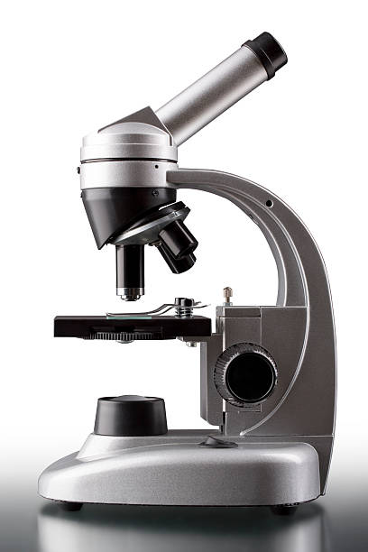 istock close up of a silver microscope, with white background 451100997