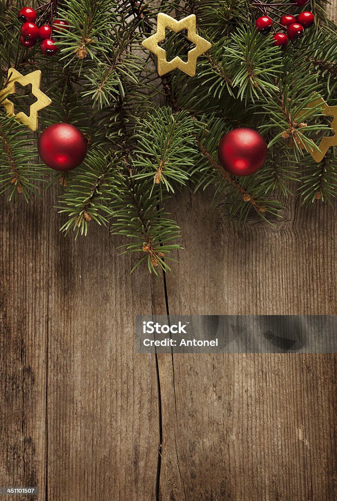 Christmas tree garland with ornaments against wood Old grunge wooden board  with Christmas border. 2014 Stock Photo