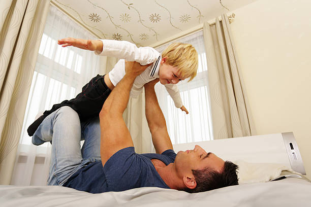 istock Father and son playing at home 451118663