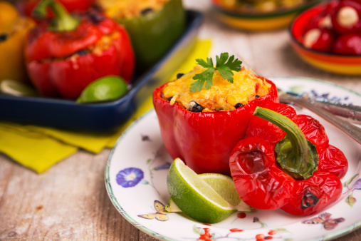 Stuffed bell peppers filled with rice and vegetables and topped with melted cheese.