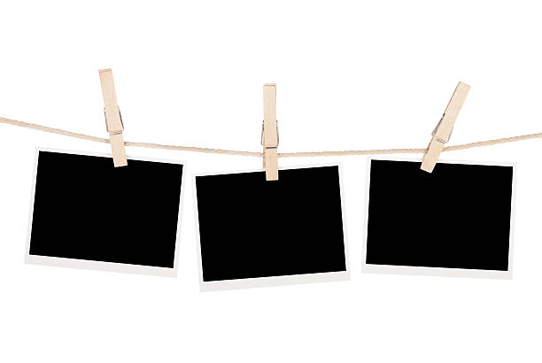 istock Blank photos hanging on clothesline 451173917