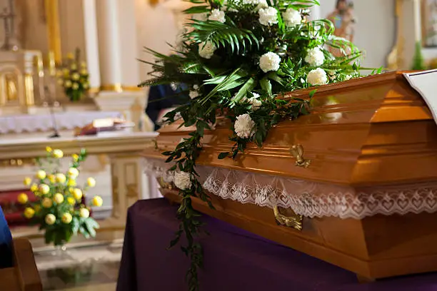 Photo of Flowers on a coffin in the church