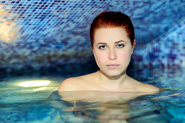 istock woman portrait in pool 451187951