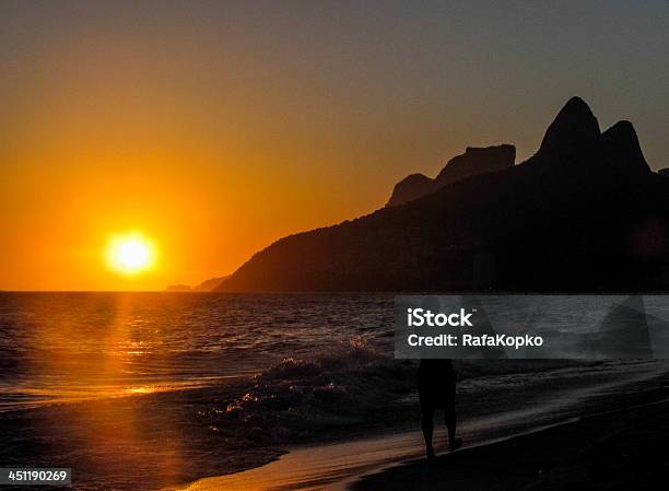 Men Walking At The Sunrise In Rio De Janeiro Stock Photo - Download Image Now - Leblon Beach, Sun, Sunlight