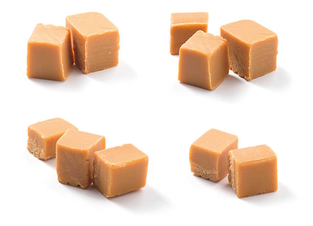 istock Cubes of caramel candies over a white surface 451243805