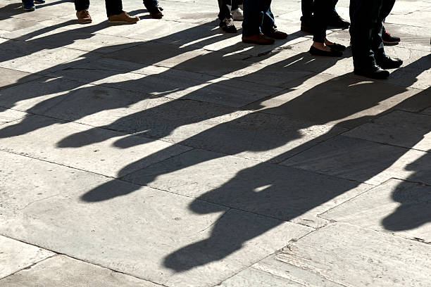 istock People standing in line. Only shoes. 451243913