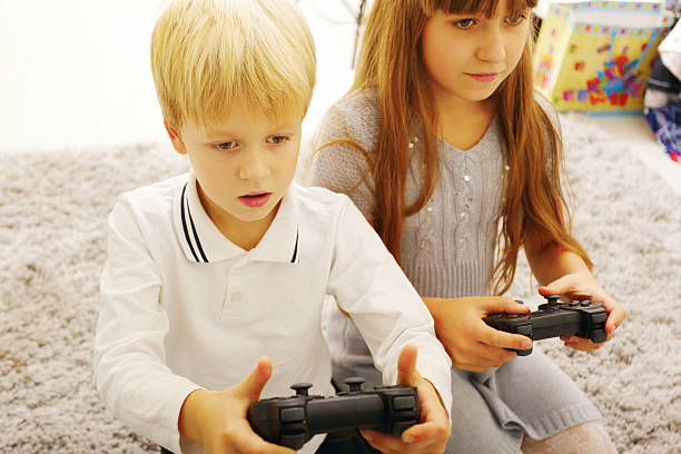istock Brother and sister playing game 451244229