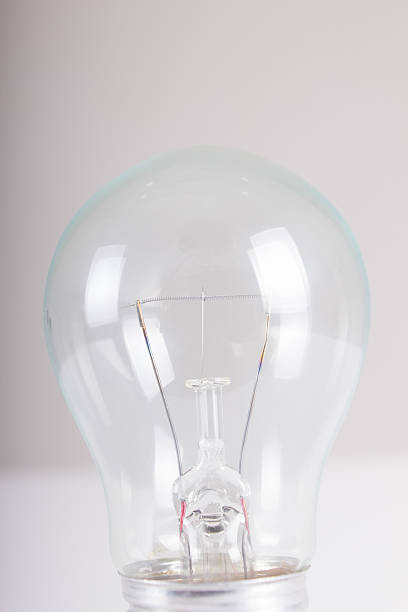 istock Clear light bulb with filament showing close up 451251535