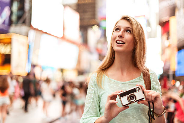 istock tourist take with a vintage camera on times square 451256835