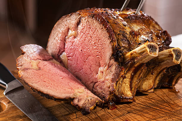 Prime Rib Roast Prime rib roast on cutting board. rib eye steak stock pictures, royalty-free photos & images