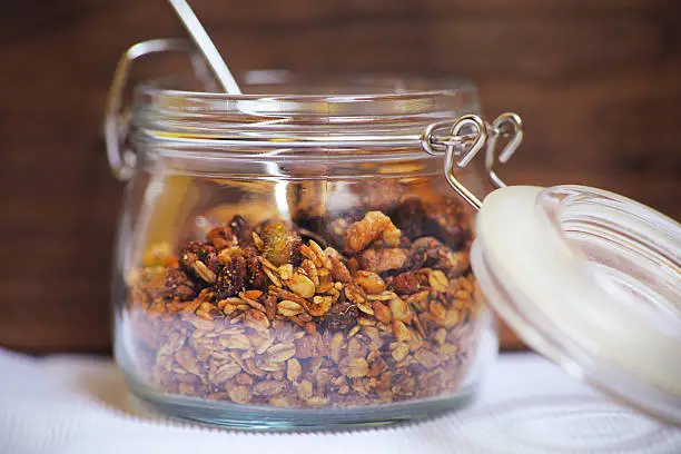 Photo of Baked granola oats with walnuts, figues, seeds in mason jar