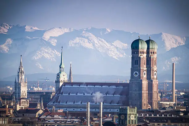 Munich covered in snow in front of the Bavarian Alps.