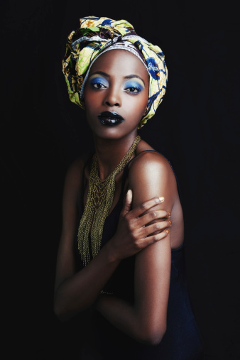 A beautiful african woman posing against a black background
