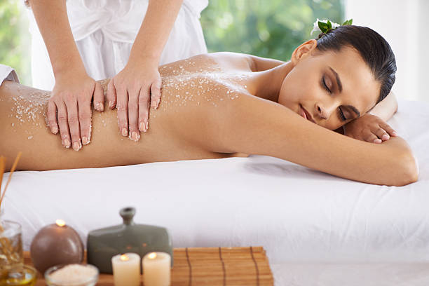 Life doesn't get better than this! Shot of a young woman enjoying a massage at a spa salt character stock pictures, royalty-free photos & images