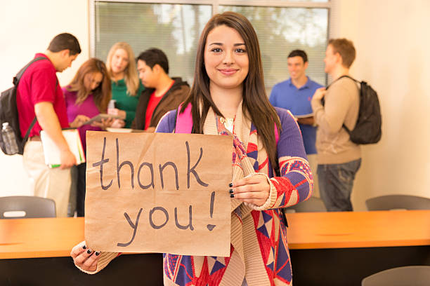 istock Education: Latin college student holds 'Thank you' sign. 451286283