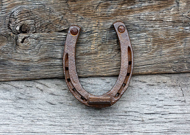 istock Old horseshoe on wooden background 451296279