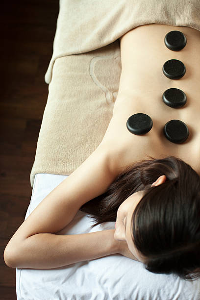 istock Young Woman Receiving Hot Stone Massage 451296745