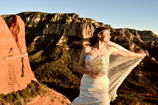 Bride in sunset light above sedona desert rock formations