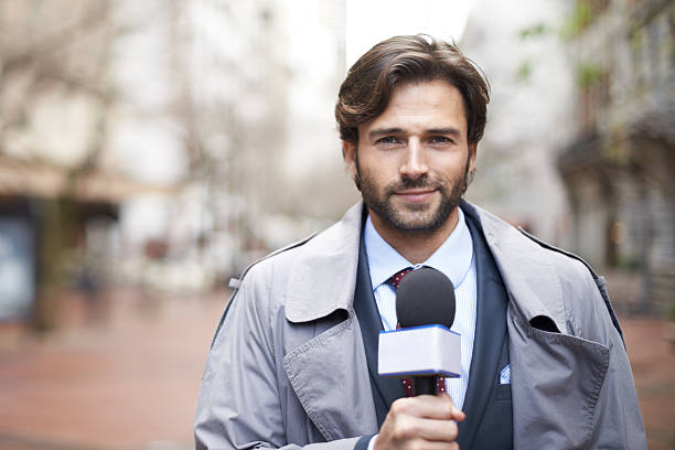 Here on the scene... Shot of a reporter ready to conduct an interview on the street tv reporter photos stock pictures, royalty-free photos & images
