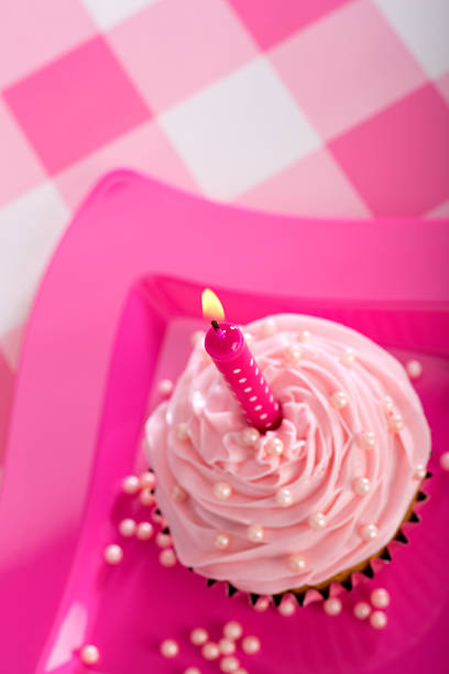 istock Cupcake with Pink Frosting and Candle on Top 451303855
