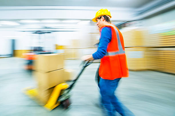 istock Worker and female manager in busy warehouse speedy working action 451303993