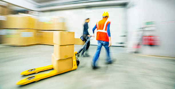 istock Worker and female manager in busy warehouse speedy working action 451304031