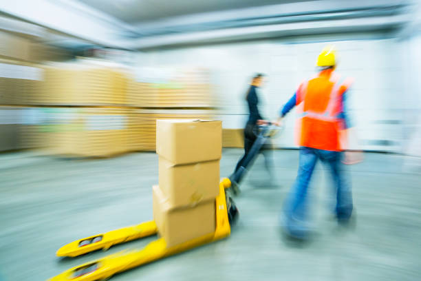 istock Worker and female manager in busy warehouse speedy working action 451304039
