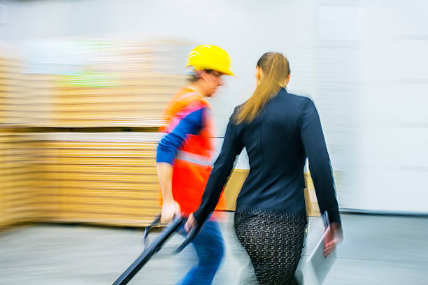 istock Worker and female manager in busy warehouse speedy working action 451304047