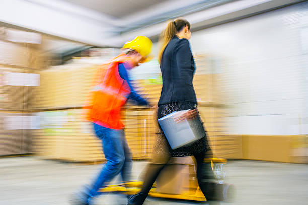 istock Worker and female manager in busy warehouse speedy working action 451304129