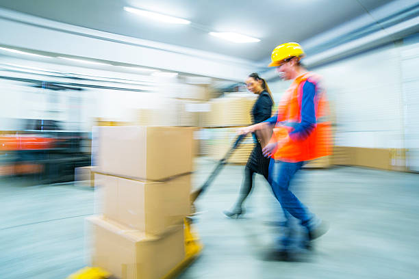 istock Worker and female manager in busy warehouse speedy working action 451304139