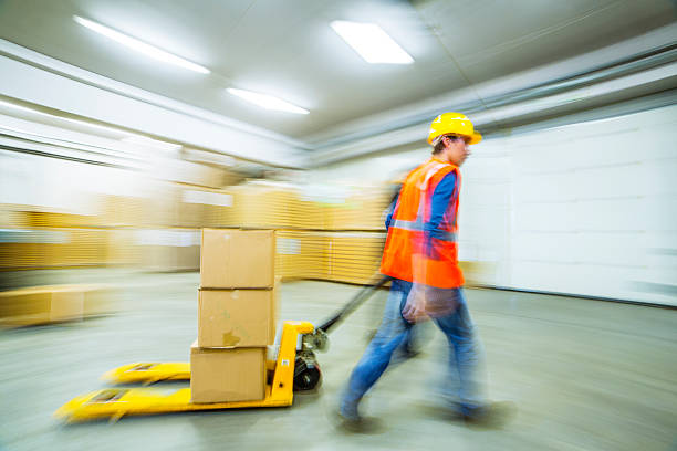 istock Worker and female manager in busy warehouse speedy working action 451304597