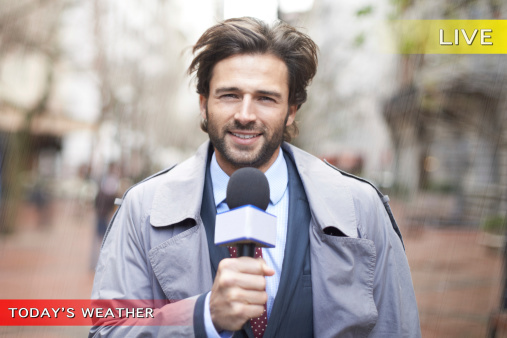 Smiling portrait of a weatherman reporting for the news