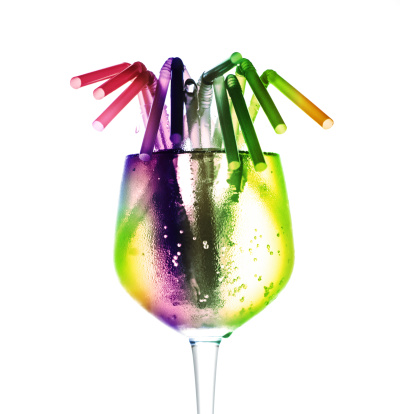 A Glass of water with straws in multi-color.
