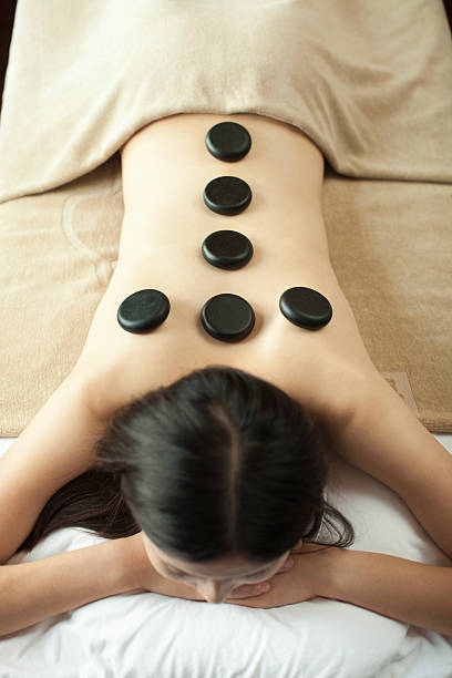 istock Young Woman Receiving Hot Stone Massage 451333561