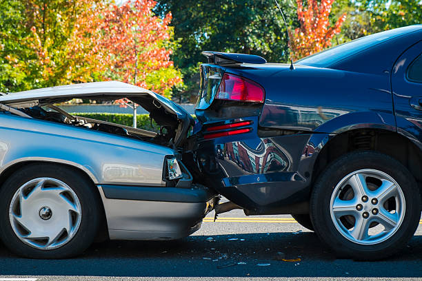 Auto accident involving two cars Auto accident involving two cars on a city street beat up car stock pictures, royalty-free photos & images