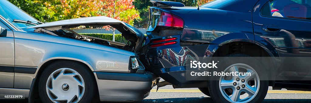 Rear end accident between two cars Auto accident involving two cars on a city street Car Accident Stock Photo