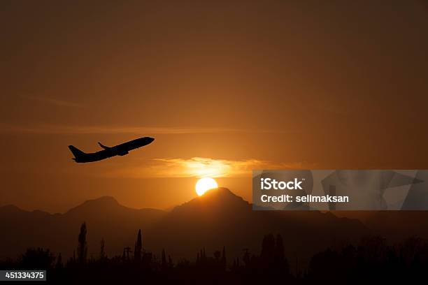 Airplane Take Of In Sunset Stock Photo - Download Image Now - Activity, Air Vehicle, Aircraft Wing