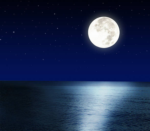 istock Brilliantly glowing full moon reflecting light off the sea 451338205