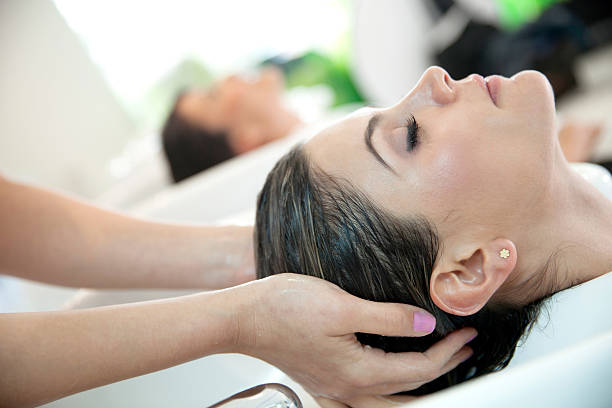 washing off after hair treatment - women human hand portrait eyes closed imagens e fotografias de stock