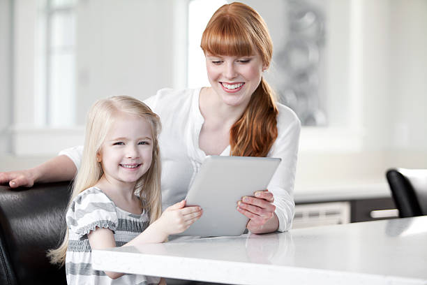 Mother and daughter looking at a digital tablet