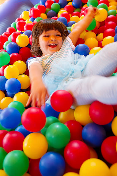 istock Little girl playing in inflatable bouncing castle 451349073