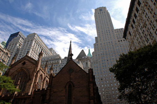 Scenic view of Trinity Church and skyscrapers on the background, Wall Street, New York City, USA