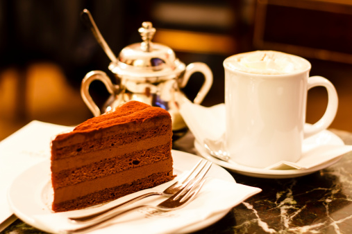 Piece of chocolate cake with almond coffee in Demel cafe, Vienna, Austria