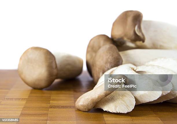 King Oyster Mushroom Stock Photo - Download Image Now - Agriculture, Brown, Cutting Board