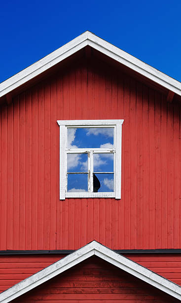 istock Broken window of an old red building 451359545