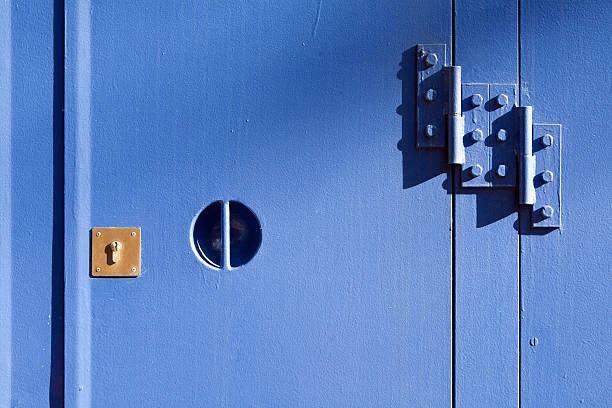 istock Lock on heavy blue metal door 451361243