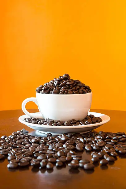coffee-bean in white mug on table