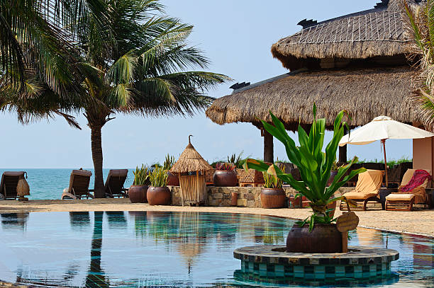istock swimming pool and sun chairs in tropical resort 451372273