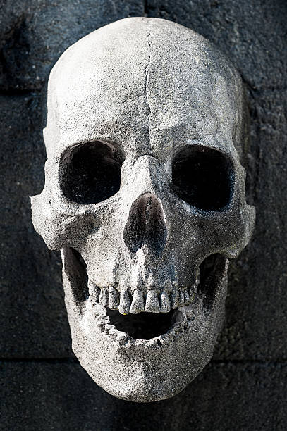 istock carving gravestone skull cemetery 451412435